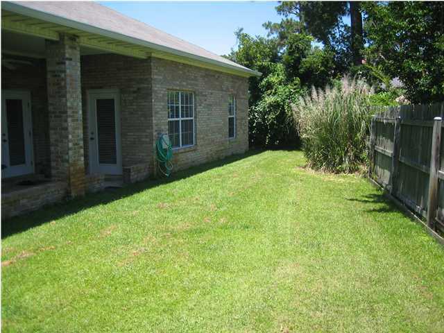 3851 Mesa Road Destin, FL 32541 - Photo 20 of 20 a view of a backyard with plants and large trees