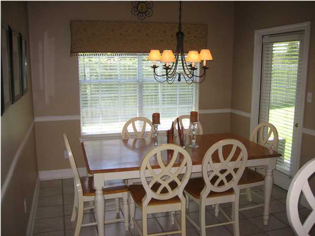 3851 Mesa Road Destin, FL 32541 - Photo 8 of 20 a view of a dining room with furniture and chandelier