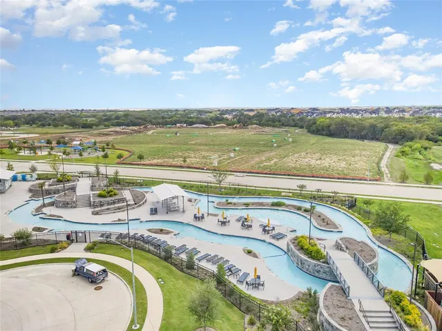 a view of swimming pool with outdoor seating and city view