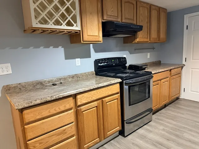 a kitchen with stainless steel appliances granite countertop a stove a microwave and cabinets