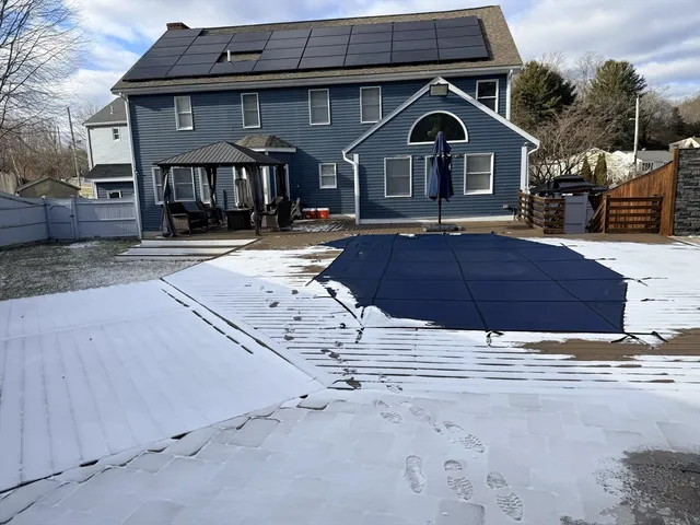 a view of a patio with table and chairs