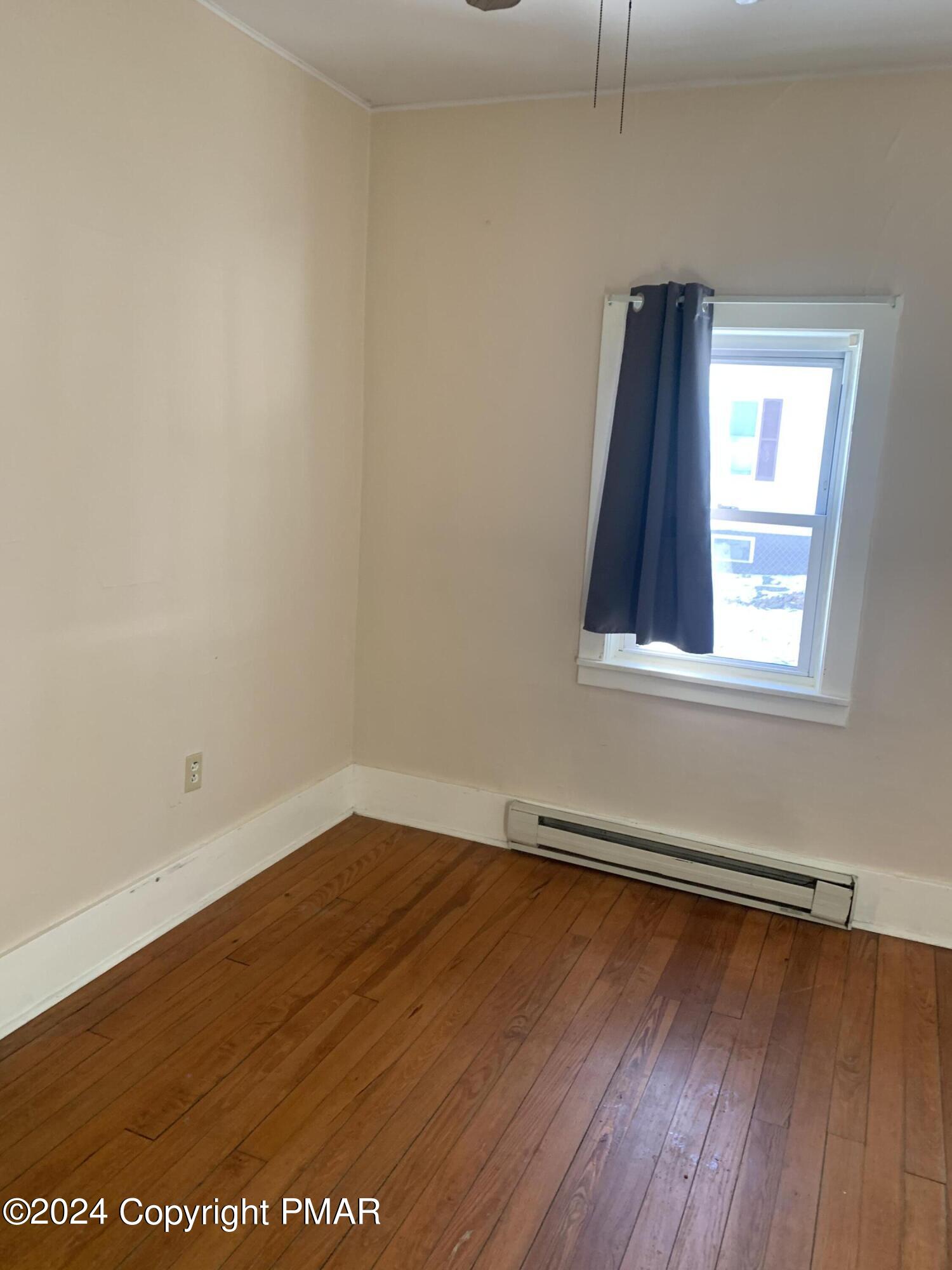 28 Reeder Street Mount Pocono, PA 18344 - Photo 12 of 17 an empty room with wooden floor and windows