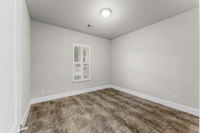 a bathroom with a granite countertop sink a toilet and shower