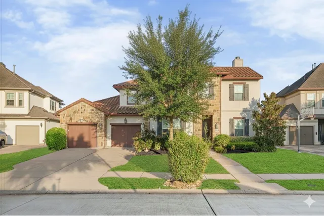 a front view of a house with a yard and a garage