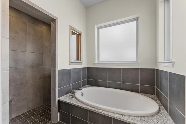 a view of a hallway with wooden floor and windows