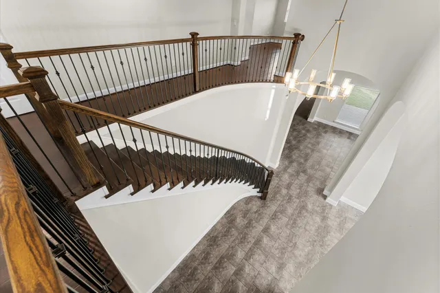 a view of a big house with a big yard and large trees