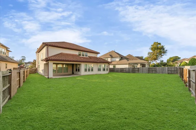 an aerial view of a residential houses with outdoor space