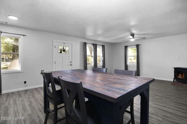 a view of a dining table and chairs in a room with a window