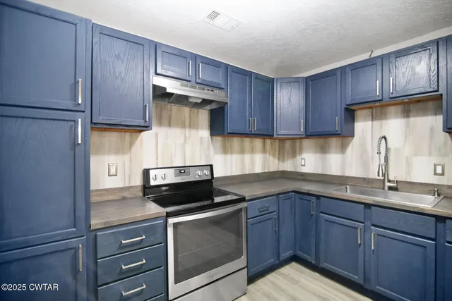 a kitchen with cabinets appliances and a sink