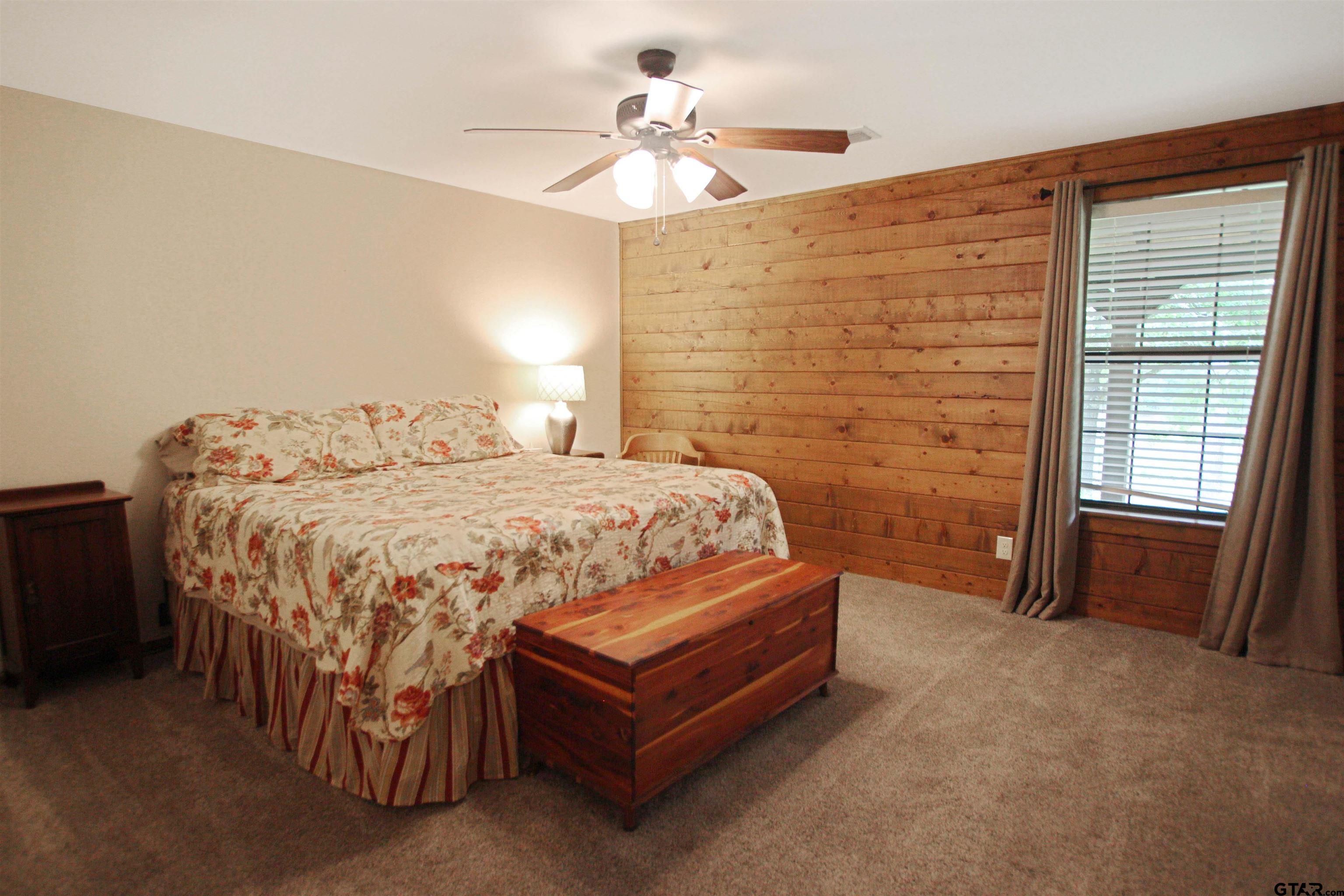 782 Rosie Wady Road Gladewater, TX 75647 - Photo 14 of 48 a bedroom with a bed and a chandelier