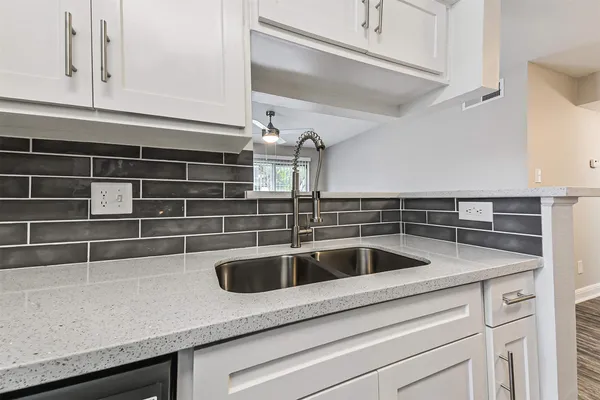 a view white cabinets and sink