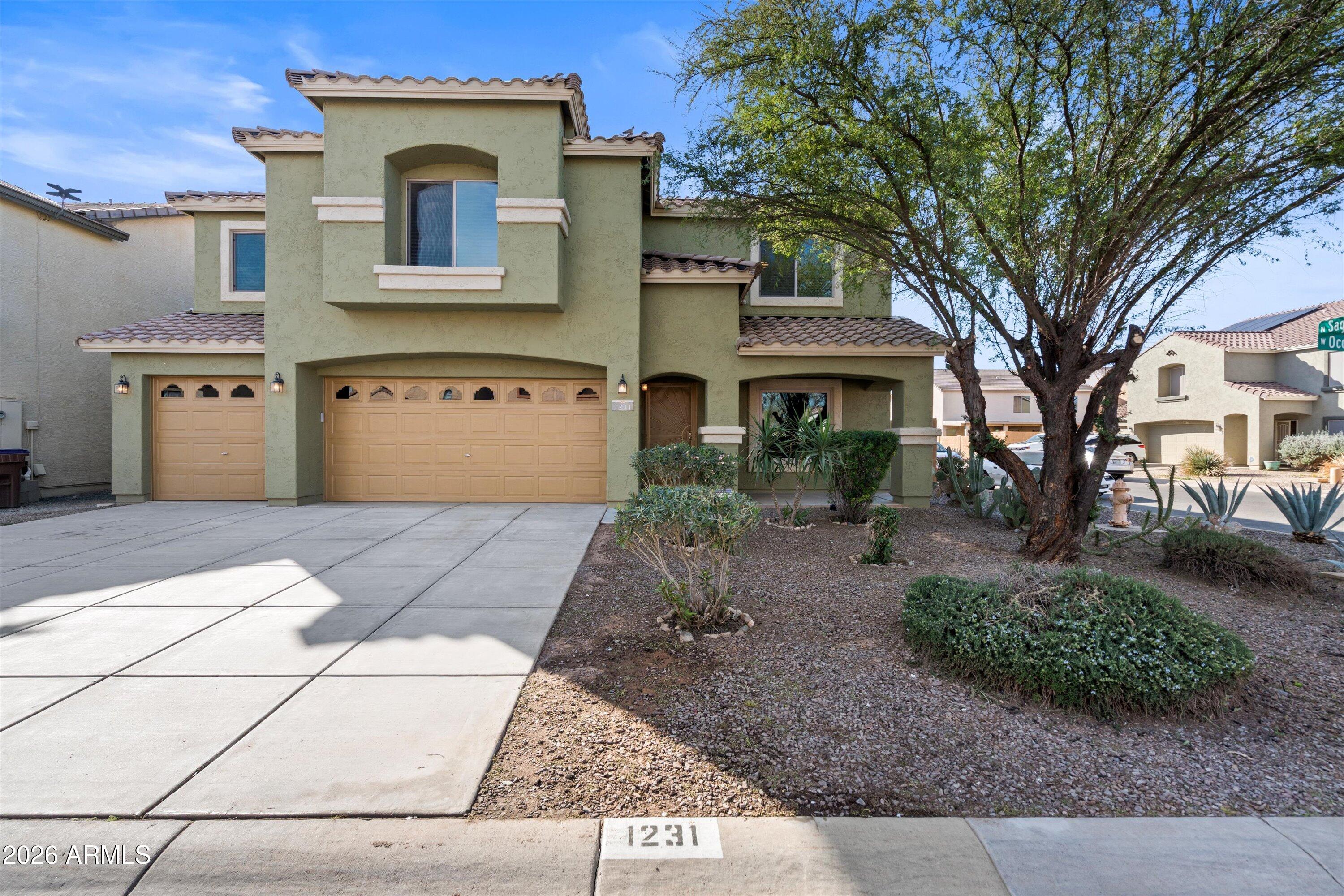 1231 West Ocotillo Street Coolidge, AZ 85128 - Photo 1 of 57 a front view of a house with garden
