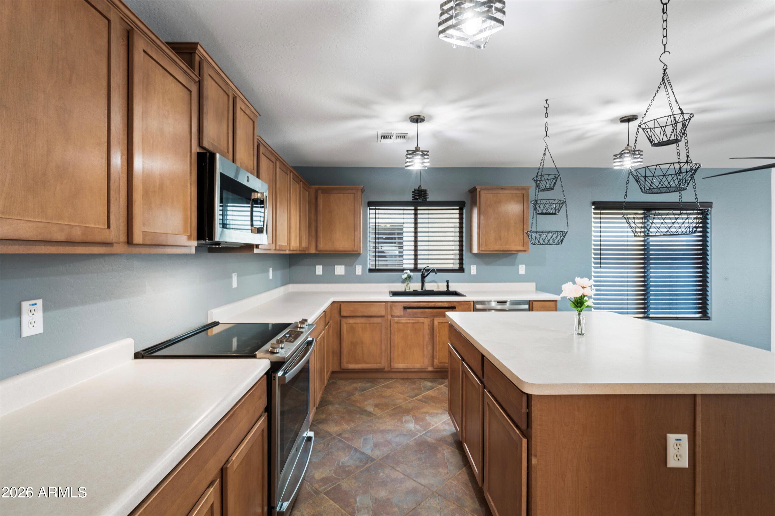 1231 West Ocotillo Street Coolidge, AZ 85128 - Photo 13 of 57 a kitchen that has a sink a stove and chairs