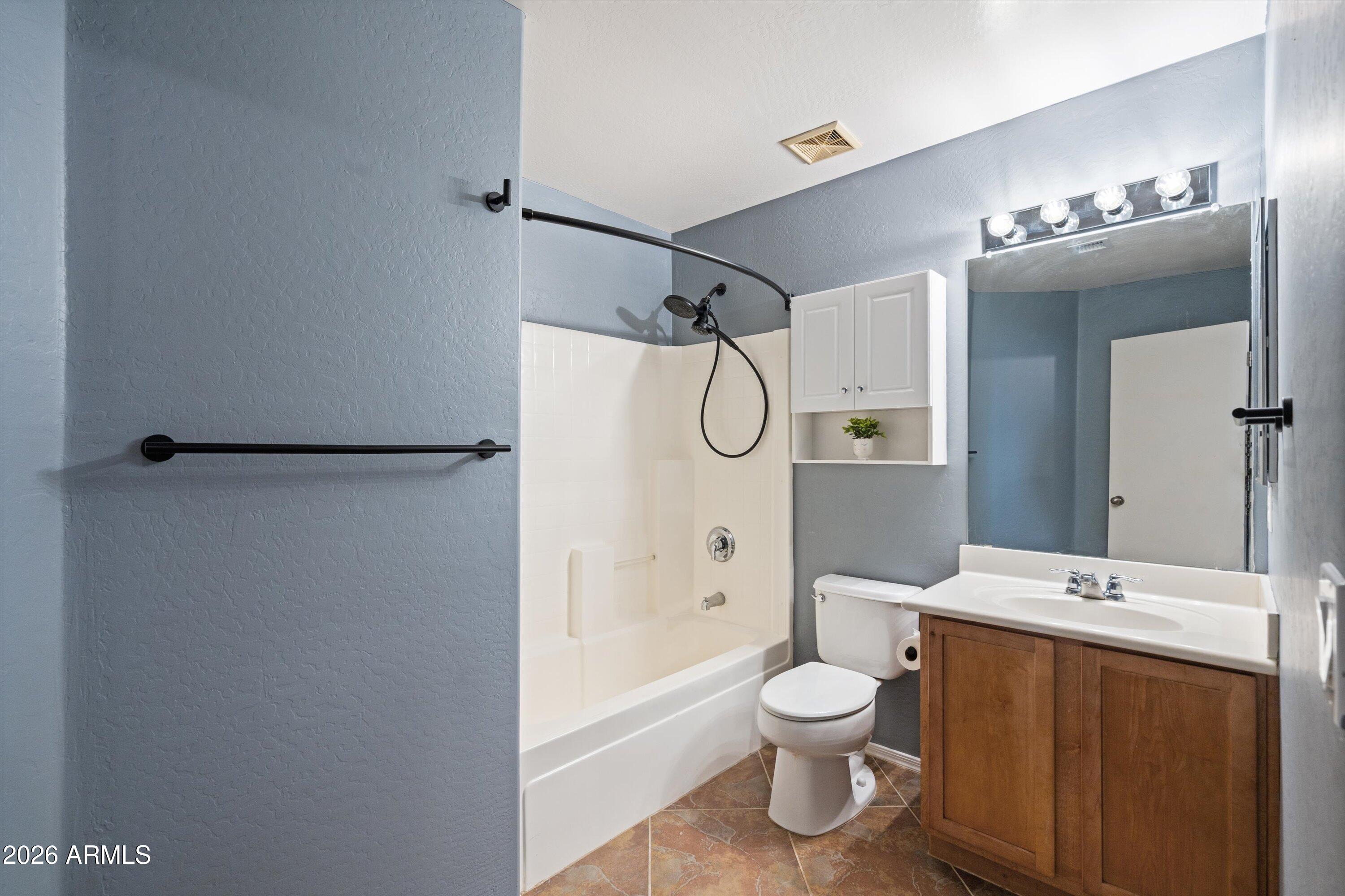 1231 West Ocotillo Street Coolidge, AZ 85128 - Photo 20 of 57 a bathroom with a toilet sink shower and mirror
