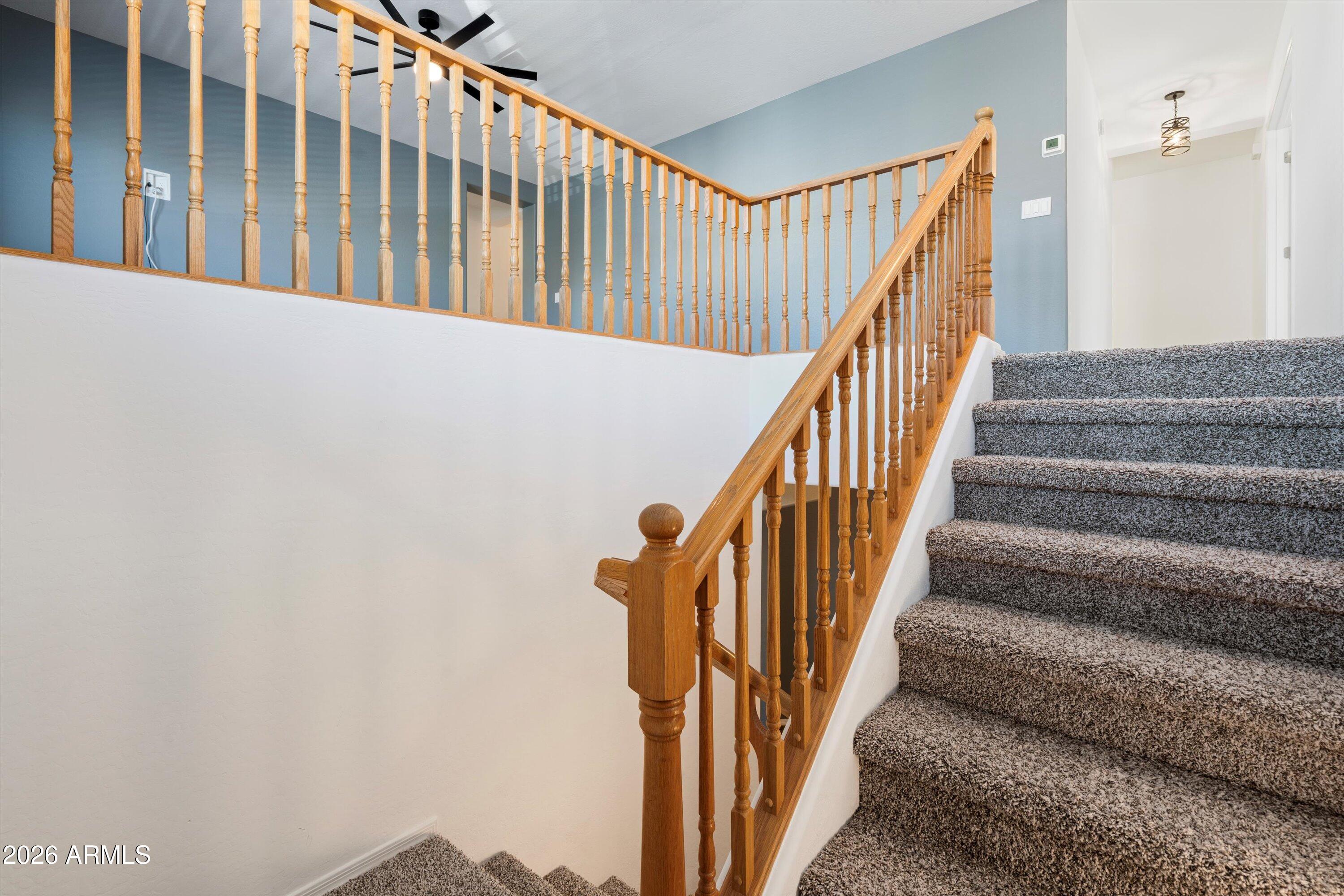 1231 West Ocotillo Street Coolidge, AZ 85128 - Photo 24 of 57 a view of staircase with lots of frames on wall