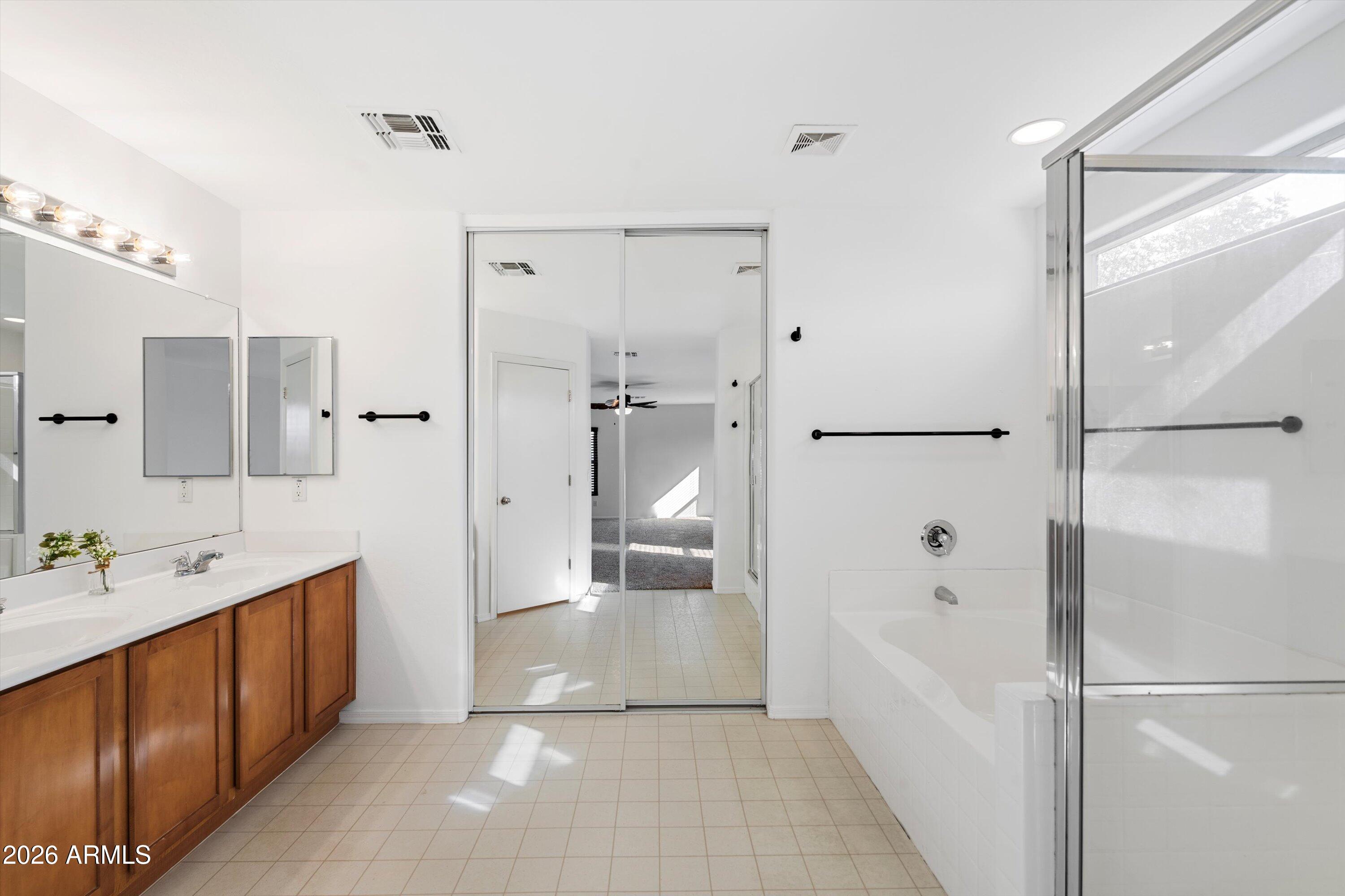 1231 West Ocotillo Street Coolidge, AZ 85128 - Photo 29 of 57 a spacious bathroom with a glass shower door and a bathtub