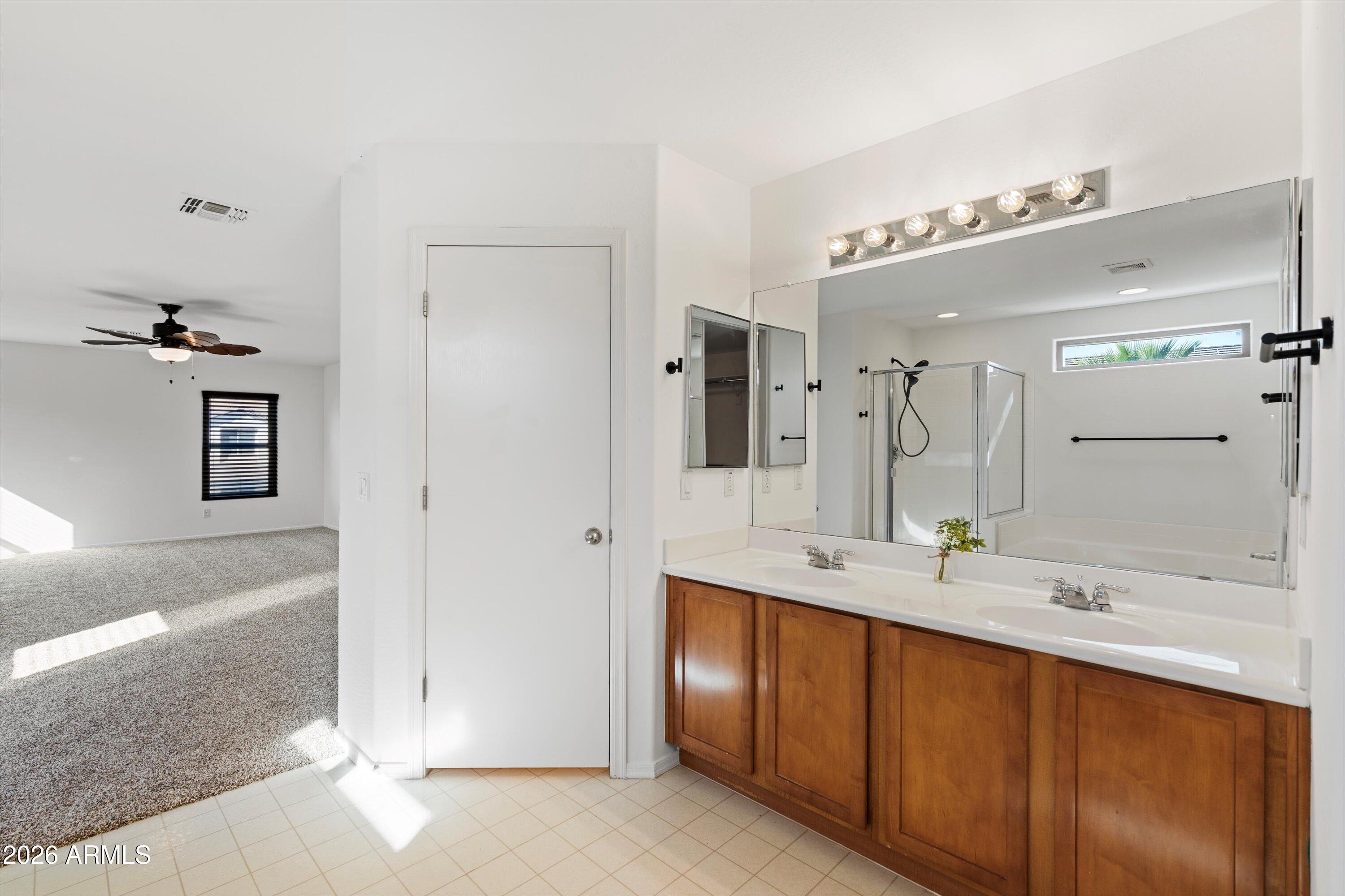 1231 West Ocotillo Street Coolidge, AZ 85128 - Photo 30 of 57 a bathroom with a double vanity sink and a mirror