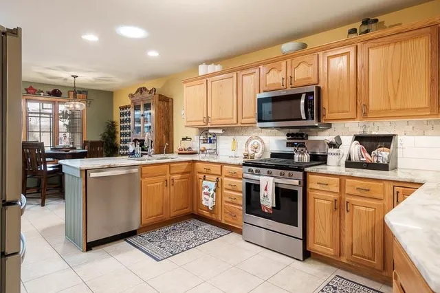 a kitchen with a sink cabinets and stainless steel appliances