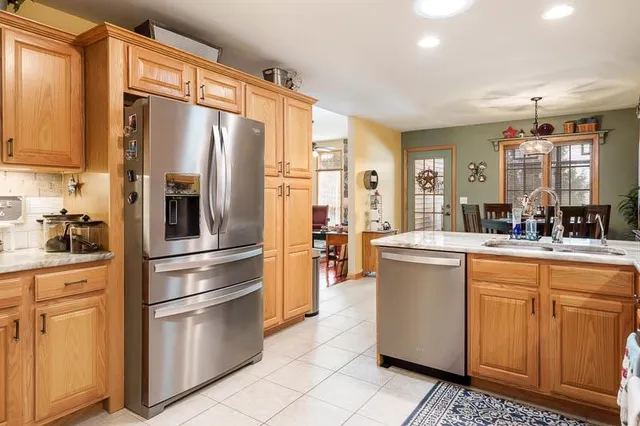 a kitchen with stainless steel appliances a refrigerator sink and cabinets