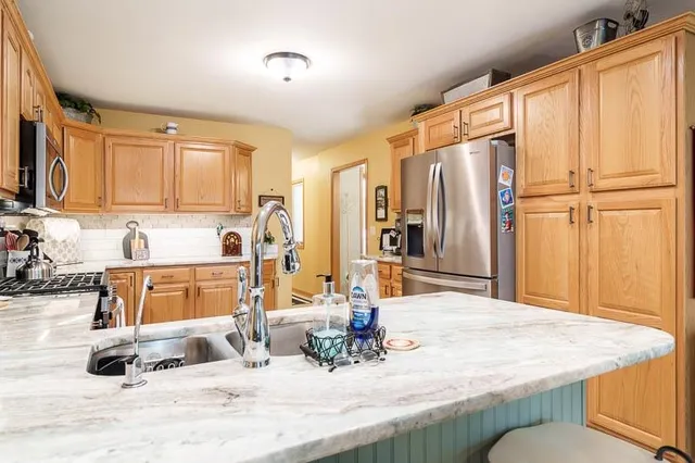 a bathroom with a tub sink and mirror