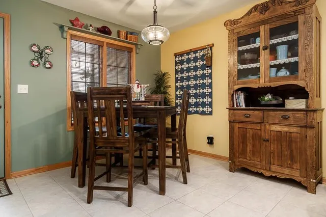 a dining room with wooden furniture and entryway