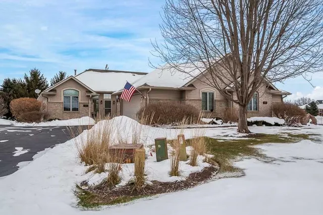 a view of a house with a yard covered in snow