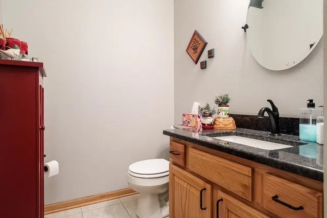 a bathroom with a toilet a sink and mirror