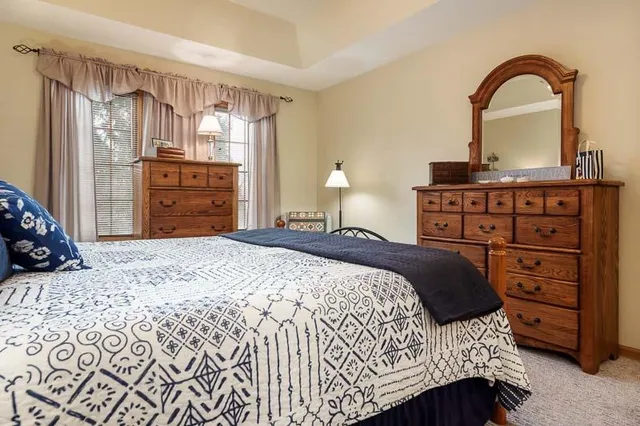 a bedroom with a bed and a dresser