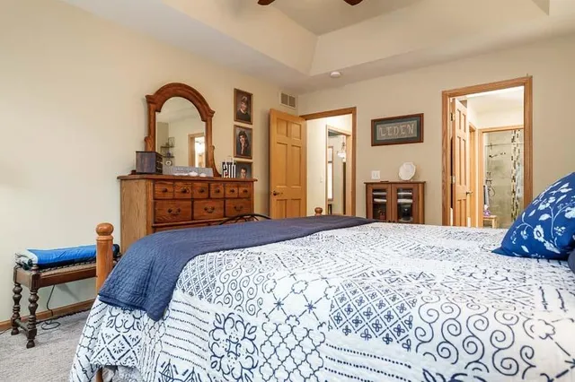 a bedroom with a bed and a dresser