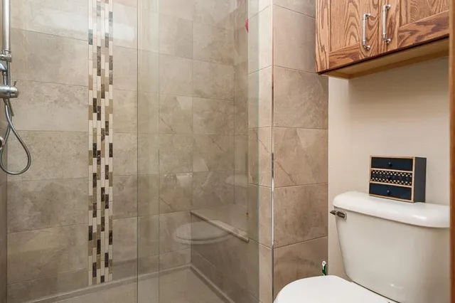 a bathroom with a toilet sink and shower