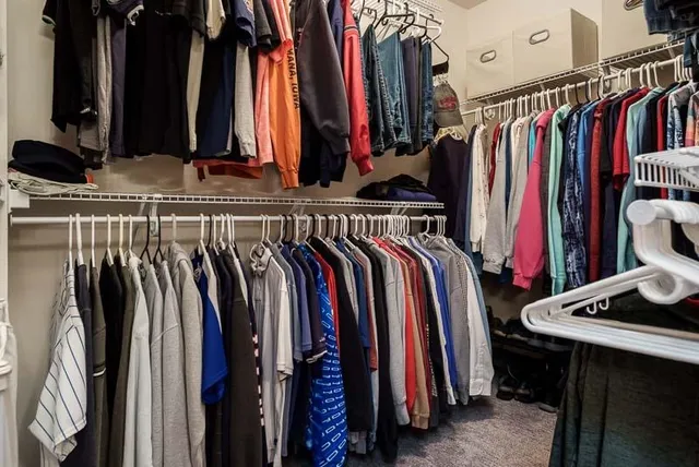a view of walk in closet with clothes