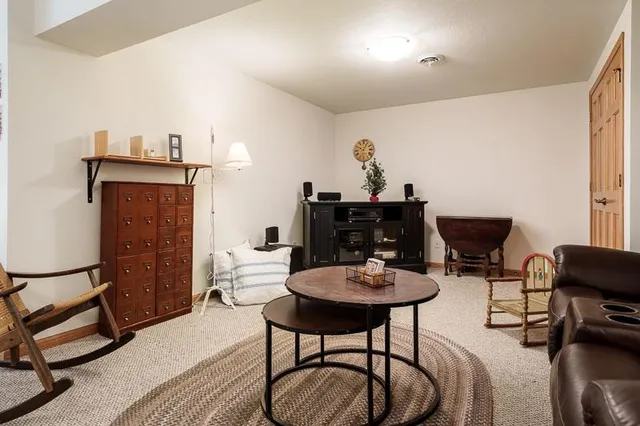 a living room with furniture a piano and a flat screen tv