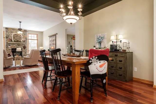 a view of a dining room with furniture wooden floor and chandelier