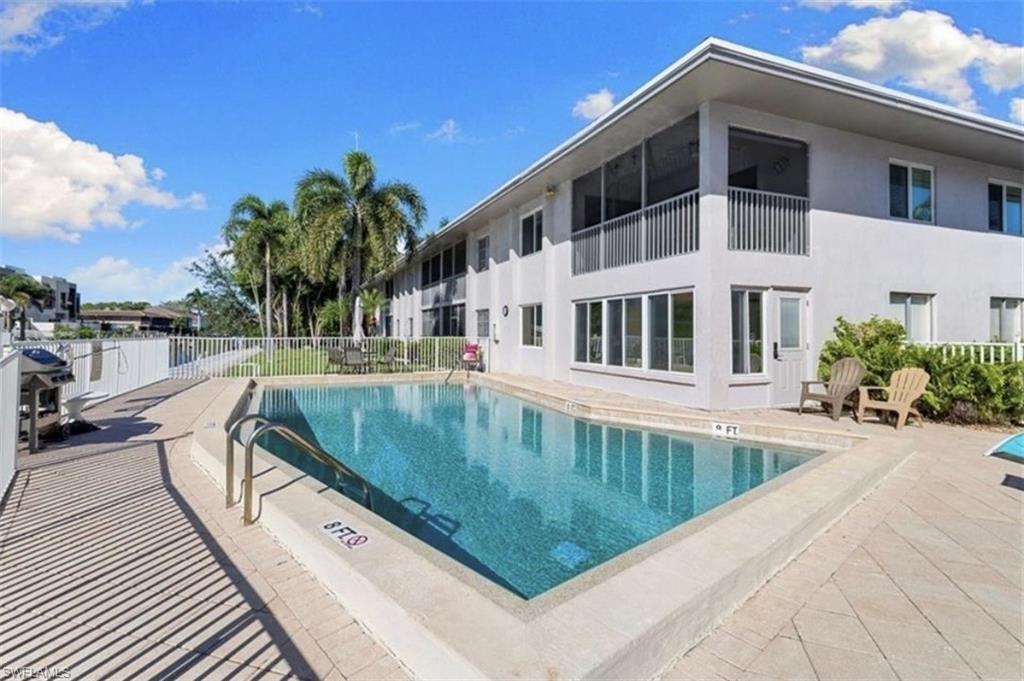 1686 Blue Point Avenue, Unit B7 Naples, FL 34102 - Photo 2 of 49 a view of swimming pool with outdoor seating