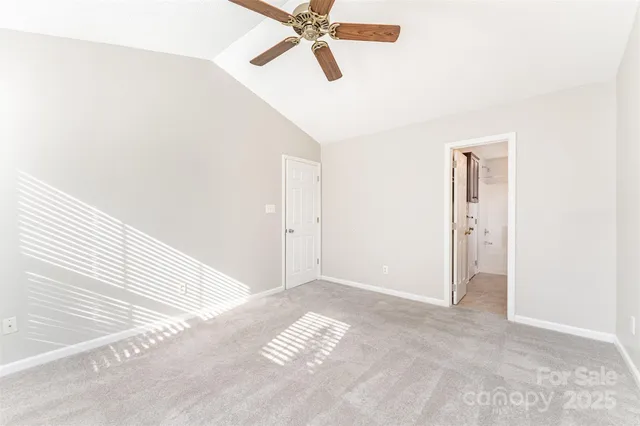 a view of a room with a ceiling fan