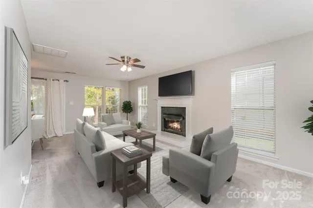 a living room with furniture a fireplace and a flat screen tv