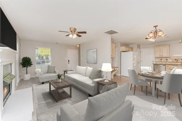 a living room with furniture a chandelier and a flat screen tv