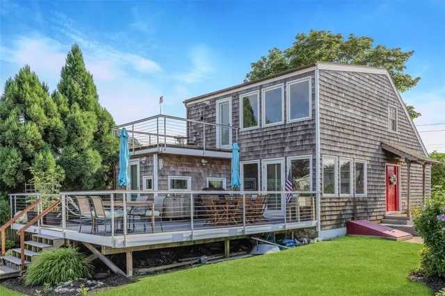 a view of a house with a yard and sitting area