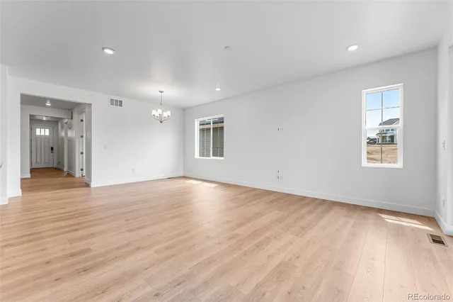 a kitchen with white cabinets and sink