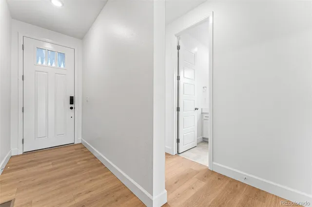 a view of kitchen with granite countertop cabinets and wooden floor