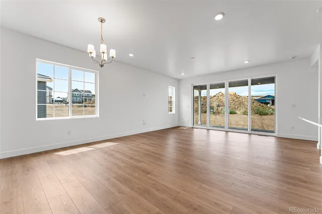 a view of a kitchen with a sink wooden cabinets and a window