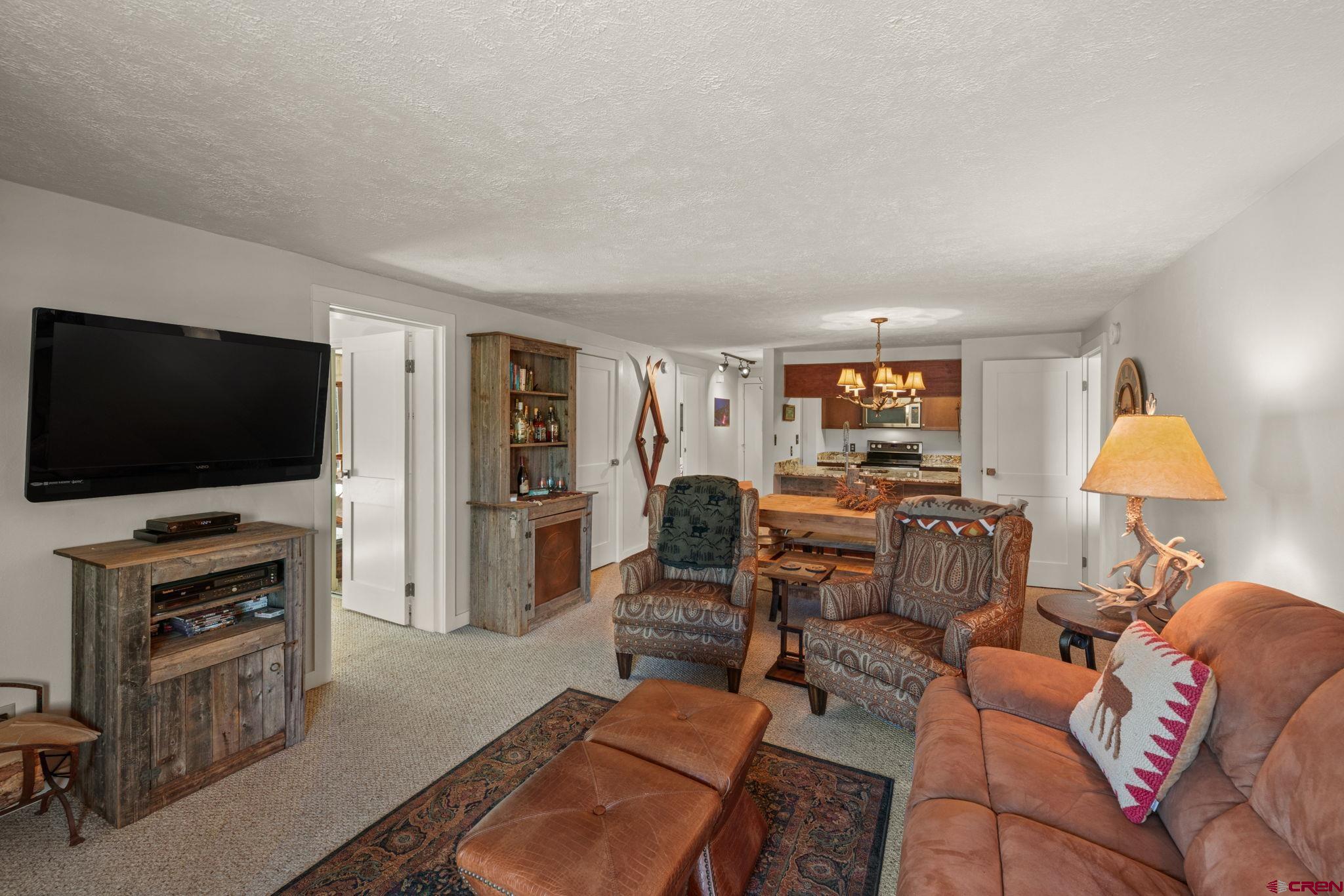 651 Gothic Road, Unit 502 Crested Butte, CO 81225 - Photo 18 of 44 a living room with furniture and a flat screen tv