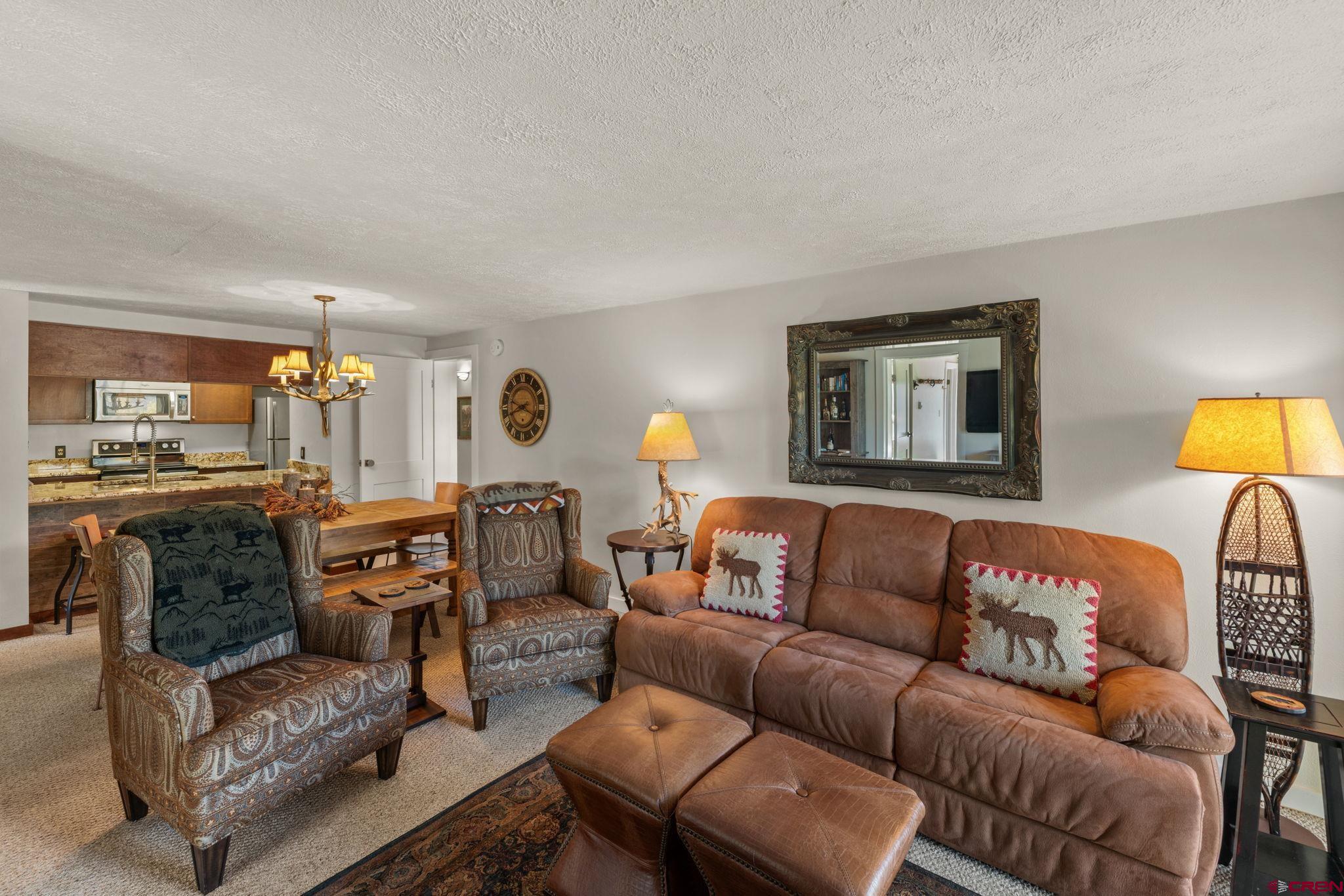 651 Gothic Road, Unit 502 Crested Butte, CO 81225 - Photo 19 of 44 a living room with furniture a lamp and a window