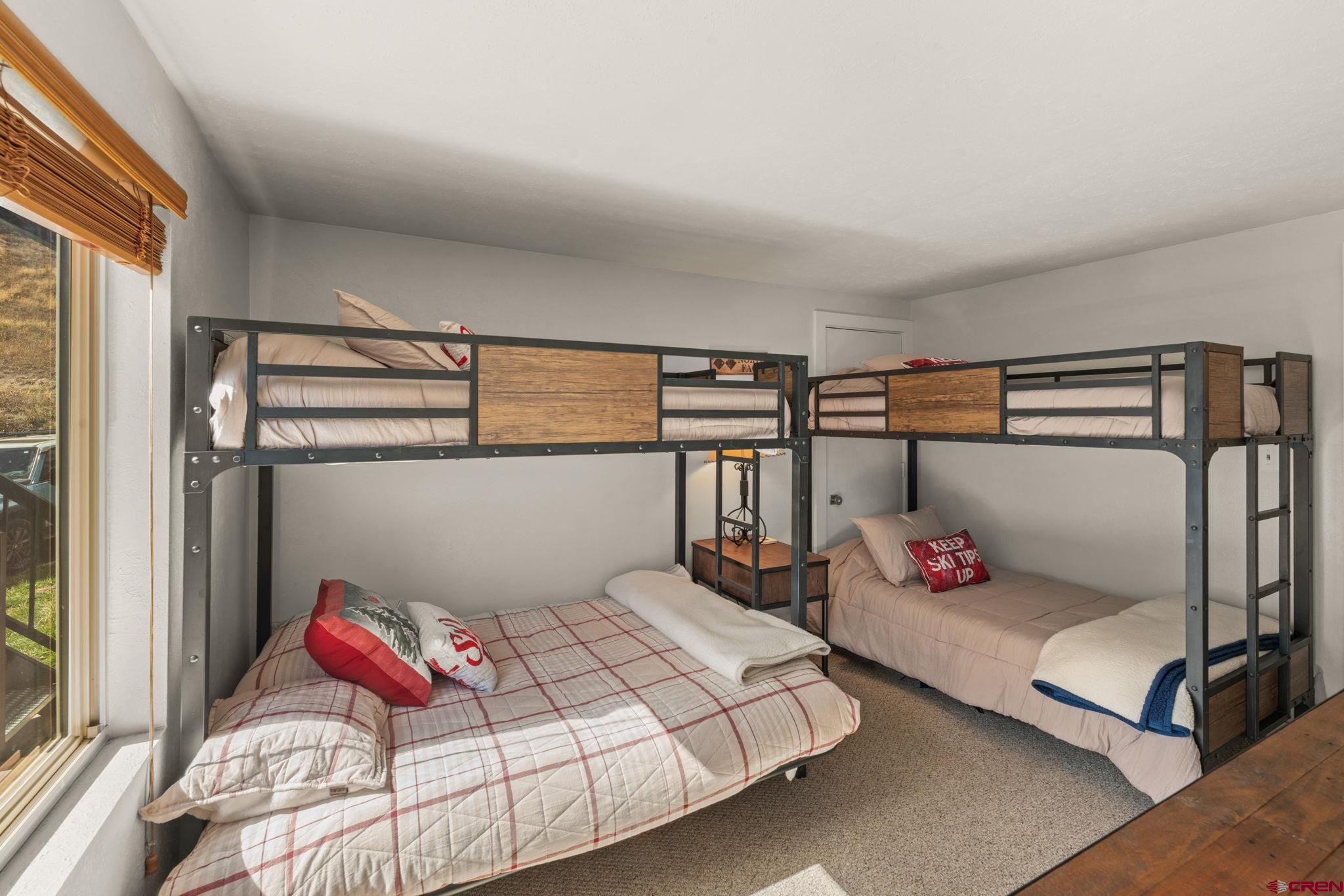 651 Gothic Road, Unit 502 Crested Butte, CO 81225 - Photo 23 of 44 a bedroom with a bed and wooden floor