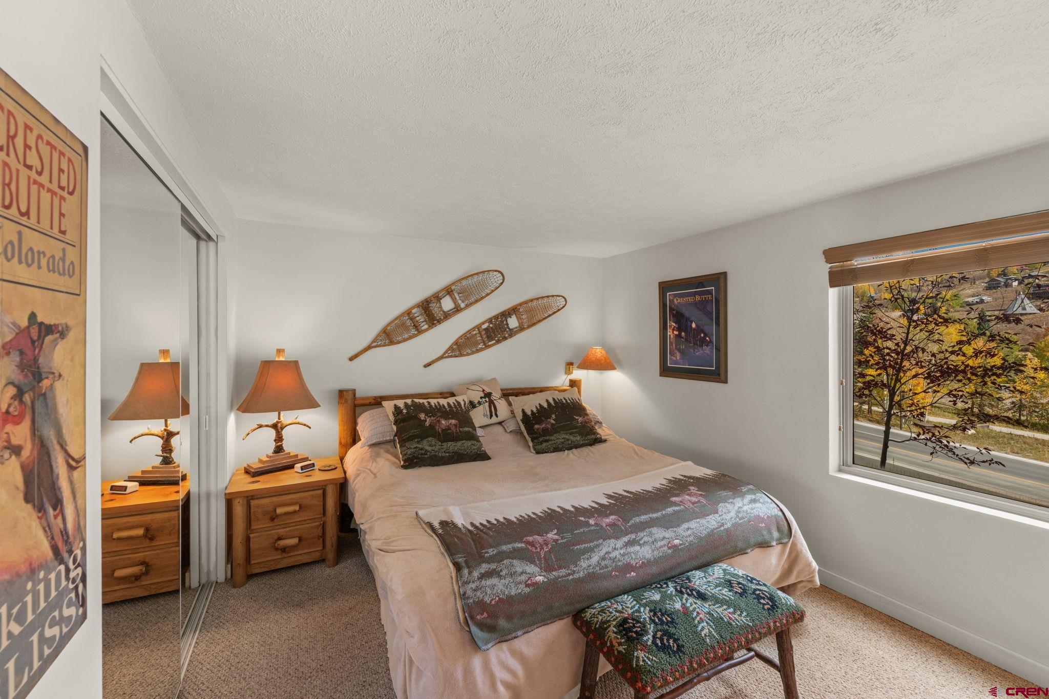 651 Gothic Road, Unit 502 Crested Butte, CO 81225 - Photo 29 of 44 a bedroom with a bed and wooden floor