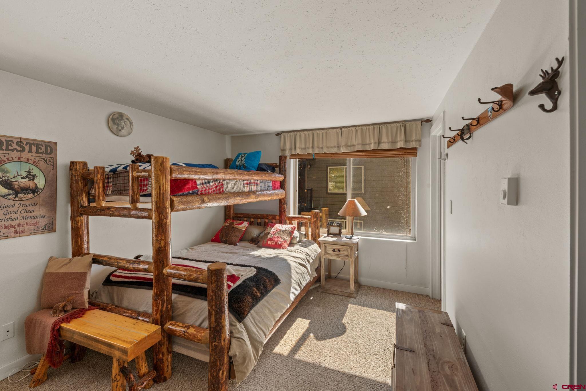 651 Gothic Road, Unit 502 Crested Butte, CO 81225 - Photo 32 of 44 a bedroom with a bed and large window