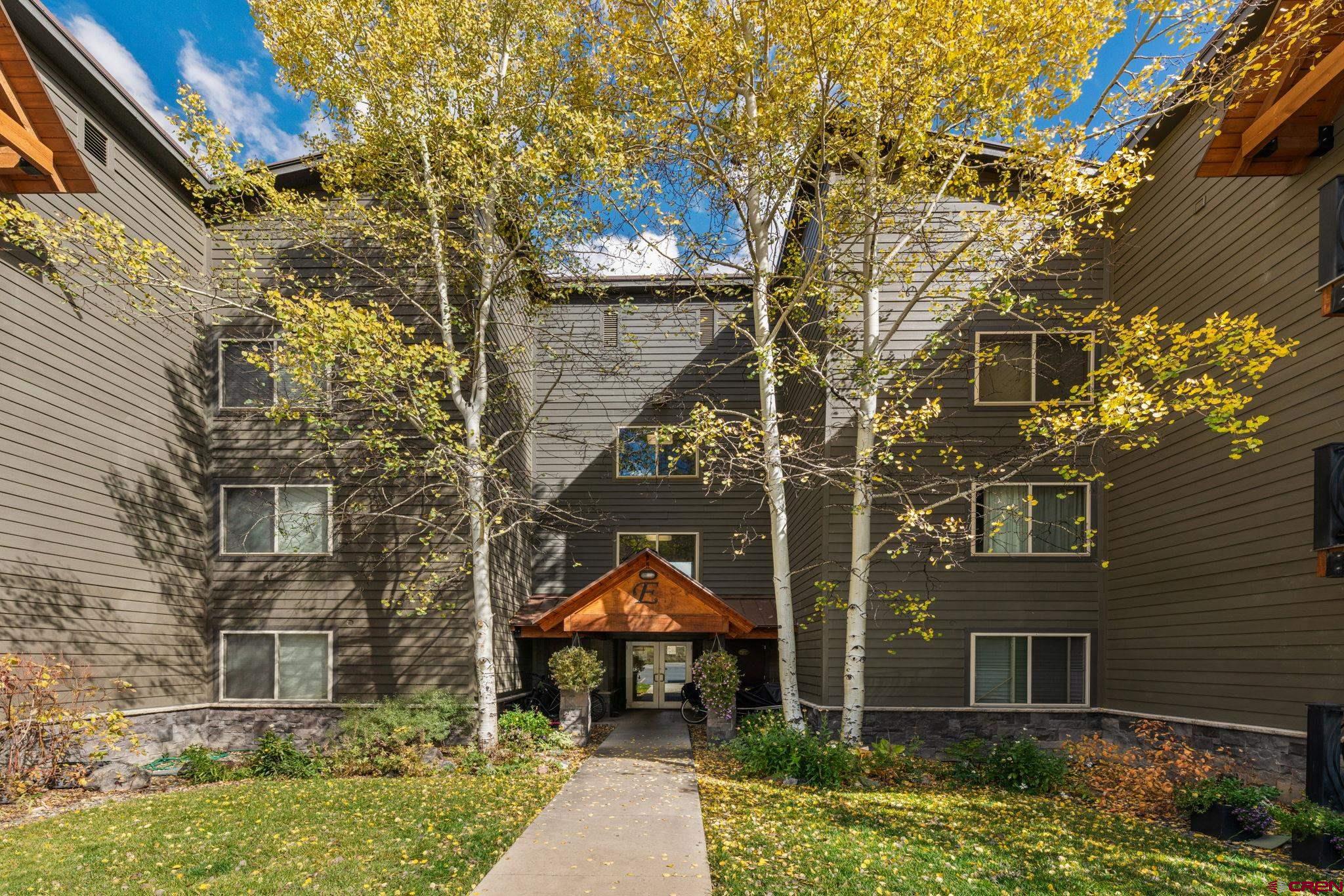 651 Gothic Road, Unit 502 Crested Butte, CO 81225 - Photo 36 of 44 front view of a brick house with a yard