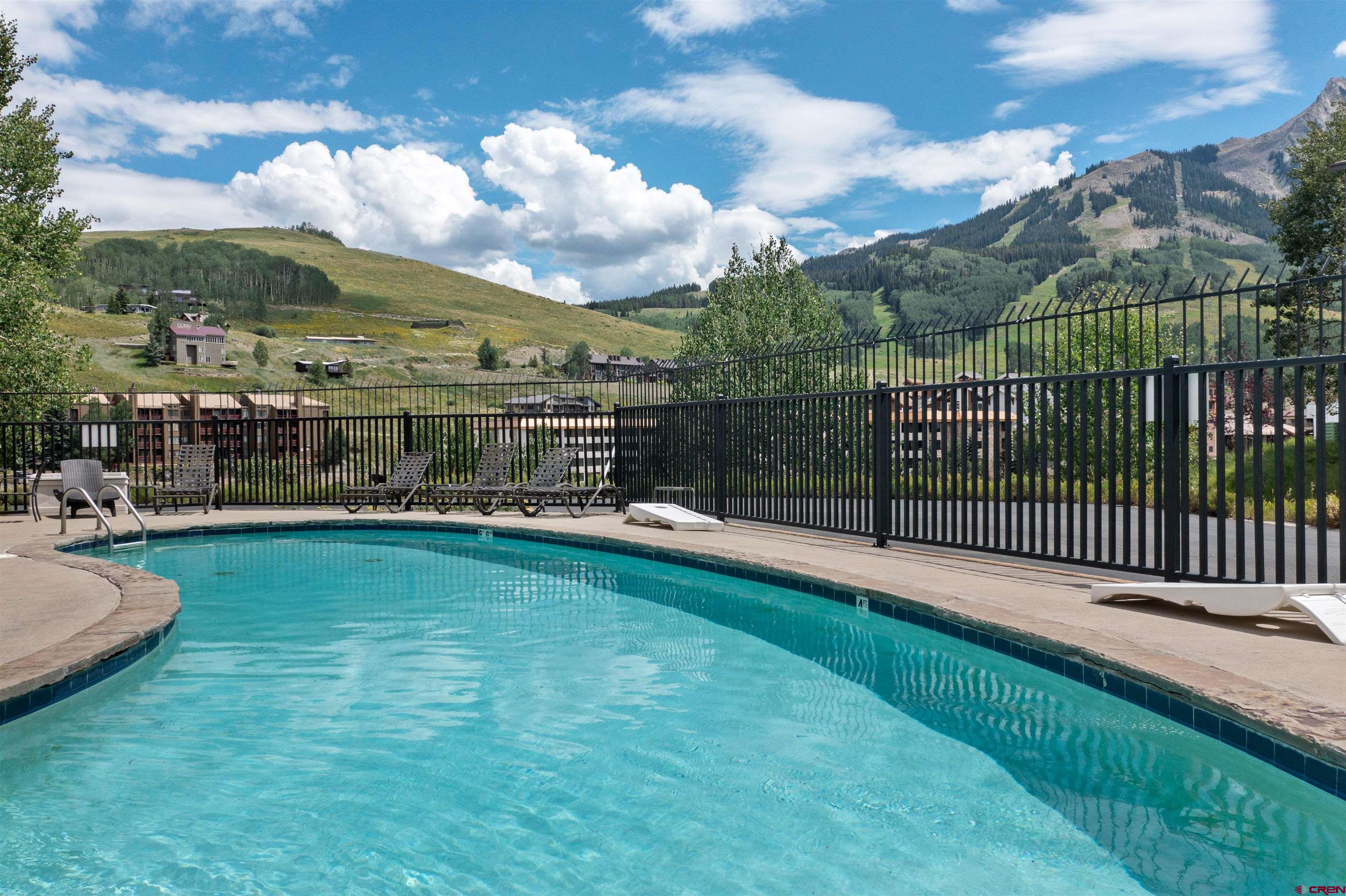 651 Gothic Road, Unit 502 Crested Butte, CO 81225 - Photo 38 of 44 a view of a swimming pool with a garden