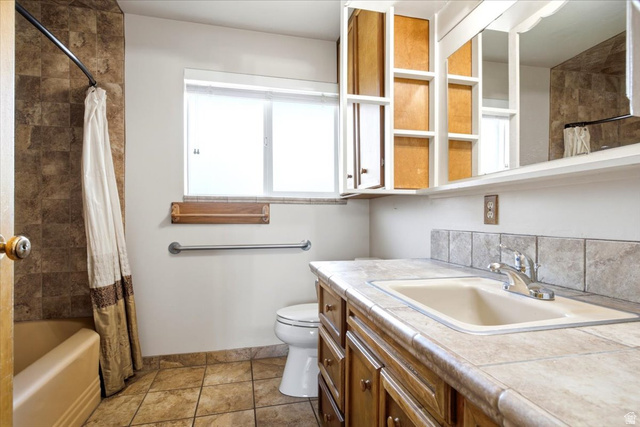 2252 West 800 North Clinton, UT 84015 - Photo 18 of 38 Full bathroom featuring a single vanity with an integrated sink, tile countertop, and a tile backsplash