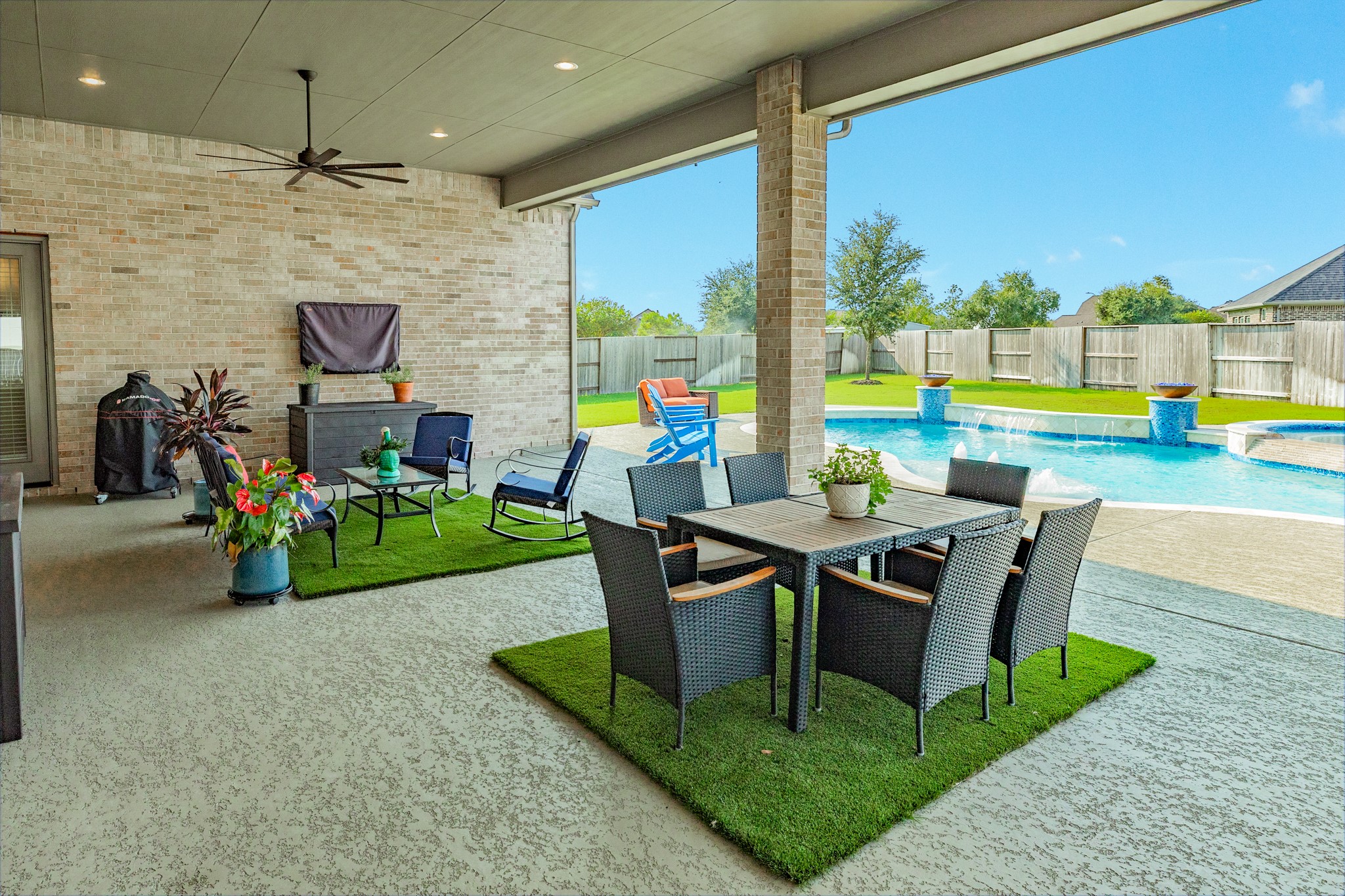 9538 Sanger Way Manvel, TX 77578 - Photo 32 of 50 Extended covered patio perfect for enjoying your morning beverage while overlooking your private oasis. This spacious outdoor retreat features recessed lighting, a ceiling fan, and textured flooring for added safety and slip resistance when wet.